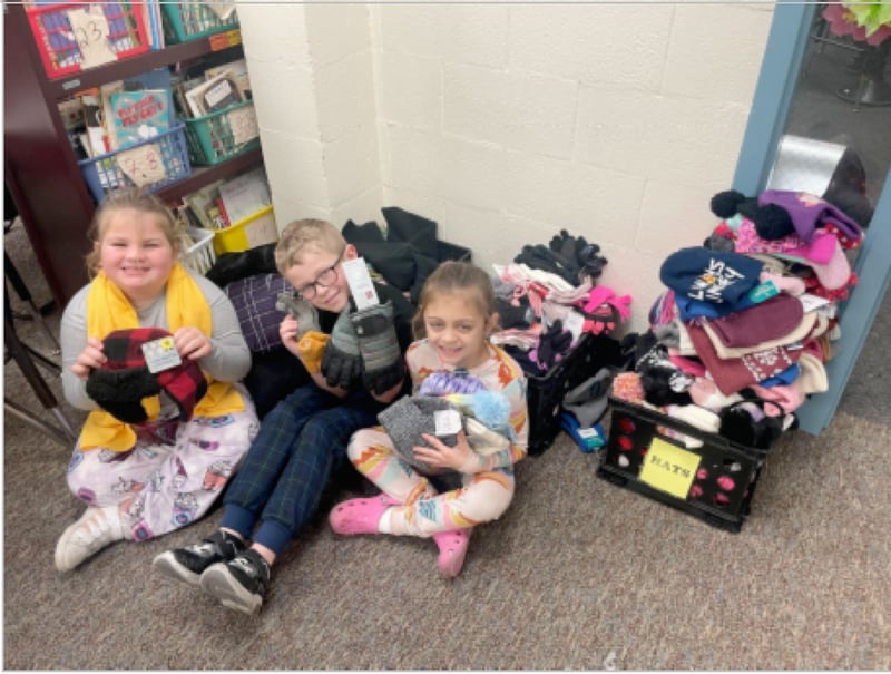 To help, students brought in these items collecting more than five crates of warm winter gear to distribute. Students helping with the collection (from left) are Avery Berg, Campbell Lesak and Izzie Zmia.