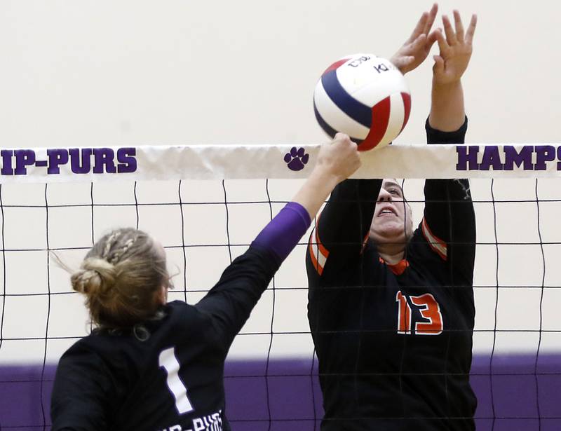 Hampshire's Elizabeth King (left) tries to hit the ball past the block attempt of Crystal Lake Central's Siena Smiejek during a Fox Valley Conference volleyball match on Tuesday, Sept. 24, 2024, at Hampshire High School.