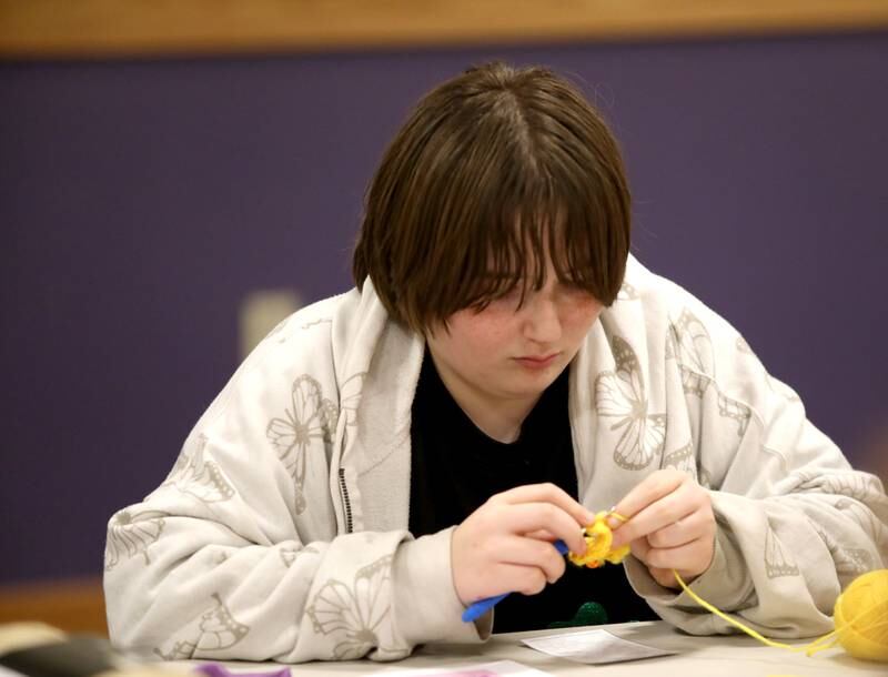 Emme Shelton, 12, of Sandwich works on a crochet project during a session of the Knit and Crochet Group at the Plano Community Library District.