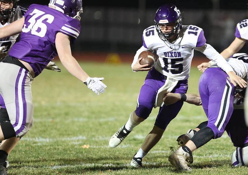 Dixon quarterback Tyler Shaner looks to get by Rochelle's Landon Delille during their first round playoff game Friday, Oct. 28, 2022, at Rochelle High School.