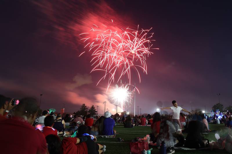 People watch the firework display from the field at Joliet Memorial Stadium in on Thursday July 4, 2024.