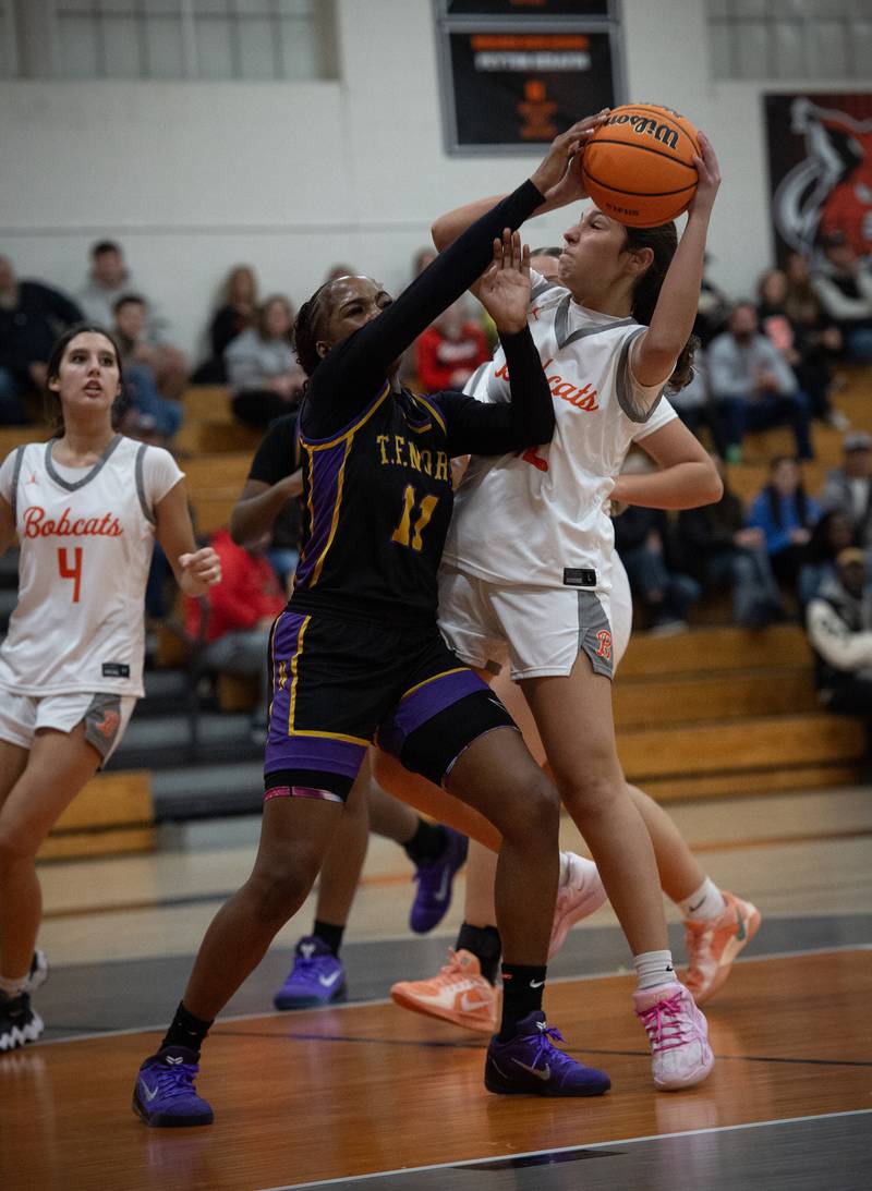 Beecher's Gianna Bonomo, right, is stopped in the lane by TF North's Natalie McGhee in the Beecher Fall Classic on Tuesday, November 18, 2025.