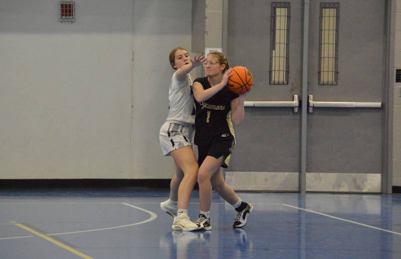 Rochelle's Tess Kissack guards a player closely during a JV basketball game with Sycamore.