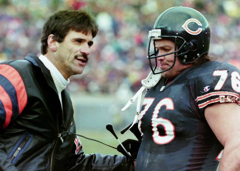 Chicago Bears head coach Dave Wannstedt and Steve McMichael chat during a game in 1990.