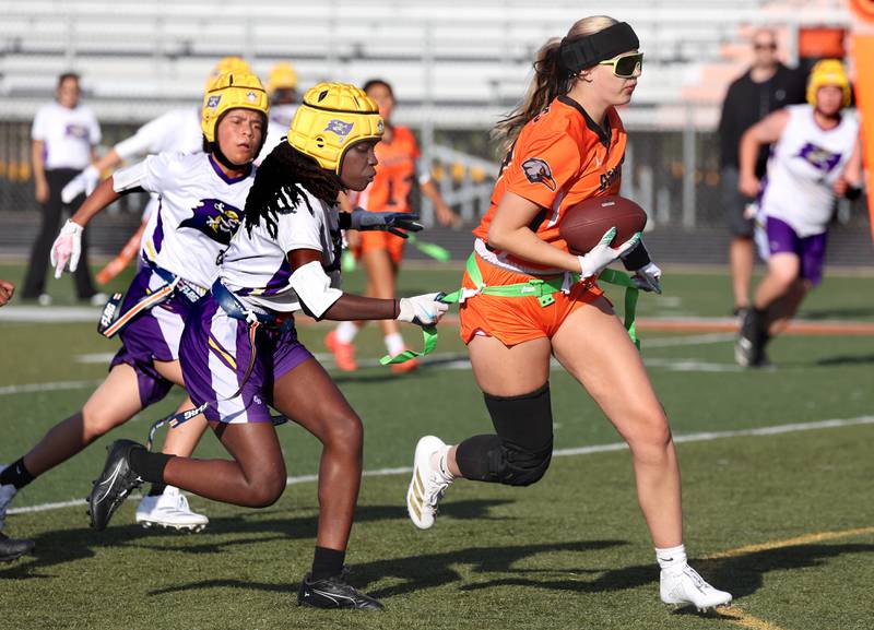 DeKalb's Elora Slater runs the ball after making an interception Monday, Aug. 25, 2025, during their game against Belvidere at DeKalb High School. The contest marked the first ever game for the girls flag football program at DeKalb.