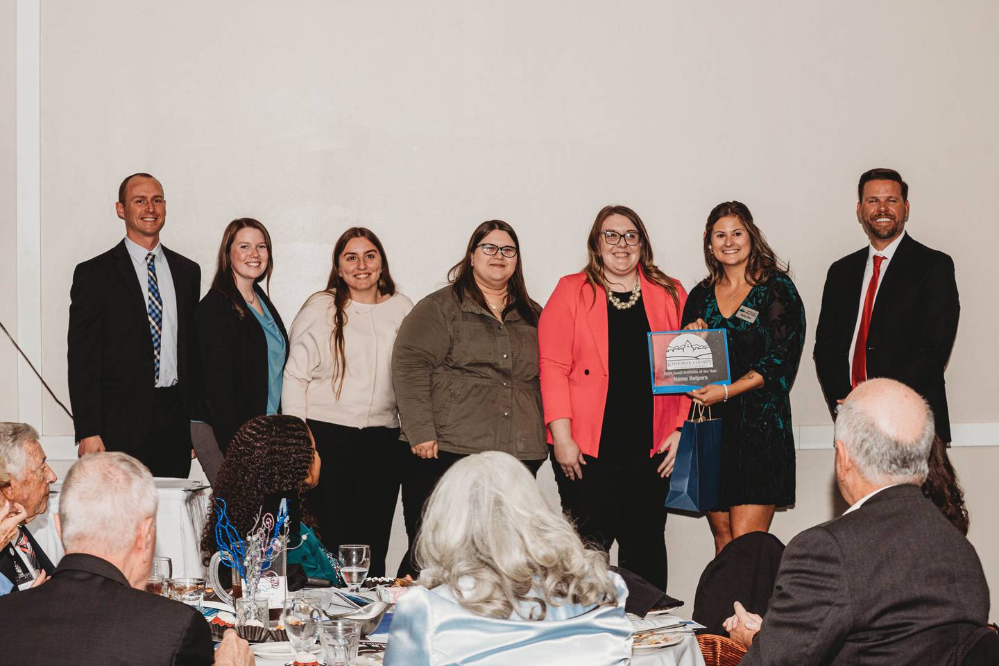 Representatives of Home Helpers Home Care of Kankakee and Frankfort accept the Small Business of the Year Award from Kankakee County Chamber of Commerce president and CEO Kelsey Post, second from right, vice chair Matthew Schore, right, and chair Rob Warmbir, left, during the chamber's annual Gala & Awards on Thursday, Nov. 6, 2025.