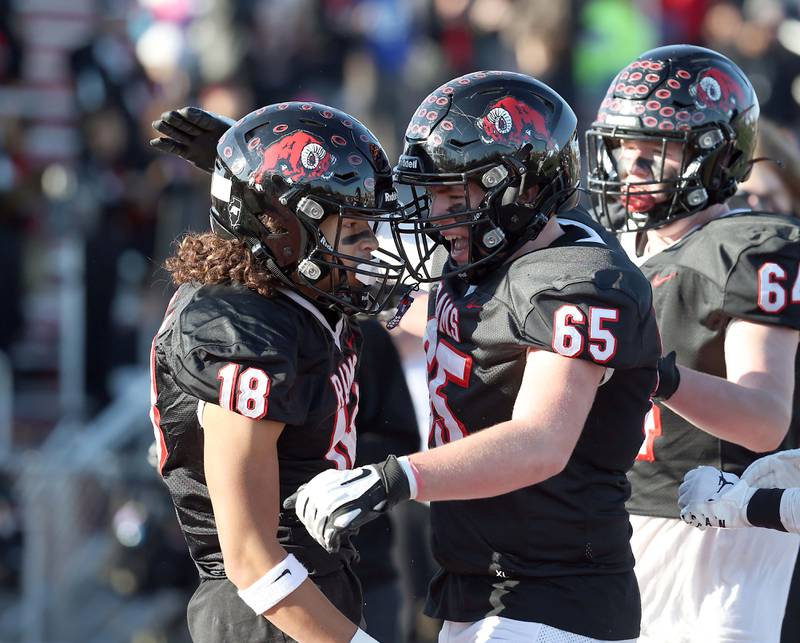 Glenbard East's Joshua Kelly (65) celebrates Chris RenfordÕs (18) touchdown during the IHSA Class 7A quarterfinals Saturday November 11, 2023 in Lombard.