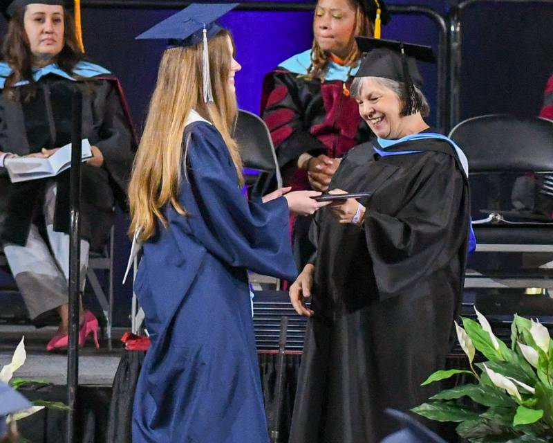 Oswego East senior Molly Nagle  receives her diploma on Saturday May 17, 2025, during the graduation ceremony held at the Convocation Center in DeKalb.