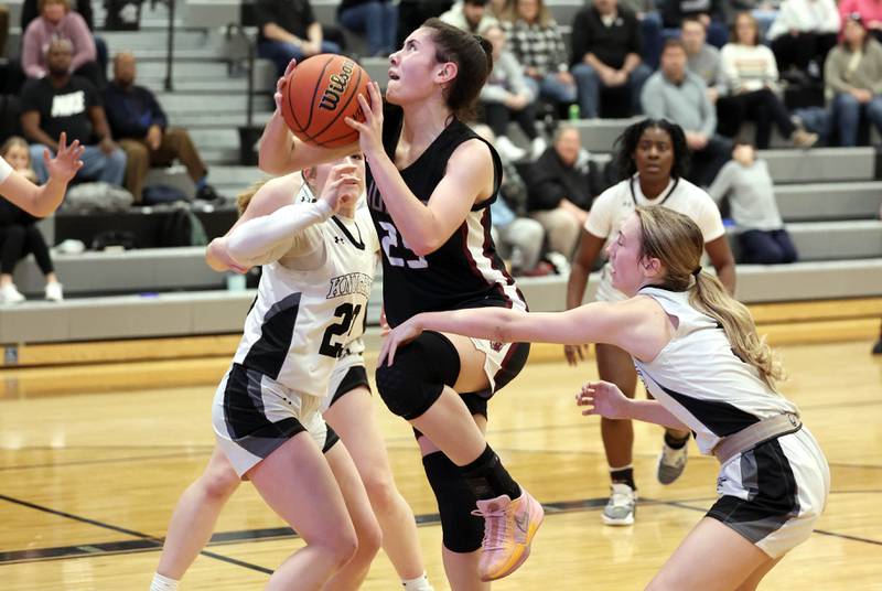 Prairie Ridge's Addie Meyer gets to the basket between two Kaneland defenders Thursday, Feb 15, 2024, during their Class 3A regional final game at Kaneland High School in Maple Park.