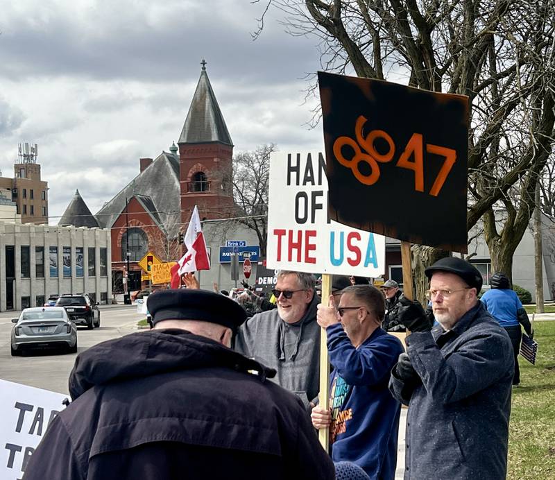Protestors gather in front of the Grandon Civic Center and the post office on Saturday, April 5, in Sterling, to voice concerns over President Donald Trump and his administration.