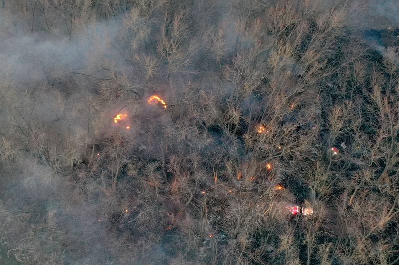 Flames emerge from a large brush fire that broke out near the 12000 block of West Bottom Road on Monday, March 2, 2025 near Granville. The fire was elevated to the second alarm as the flames spread further west. Over 150 acres of timber burned along the Illinois River during the incident.