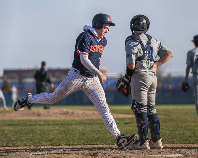 Oswego's Quinn Stanley (12) crosses the plate for a score during baseball game between Plainfield South at Oswego on Monday, April 14, 2025 in Oswego.