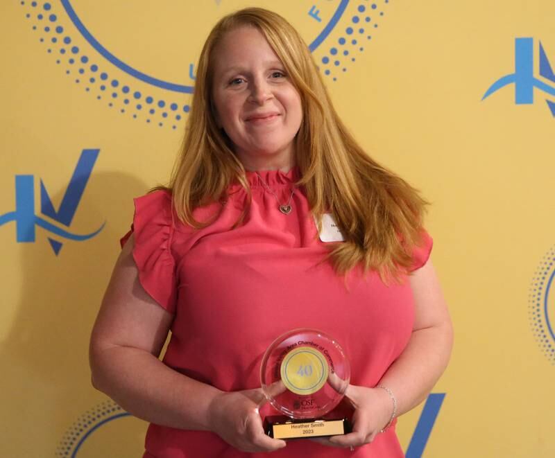Heather Smith poses for a photo with her award during the 40 Under Forty awards banquet on Thursday, March 21, 2024 at Westclox in Peru.