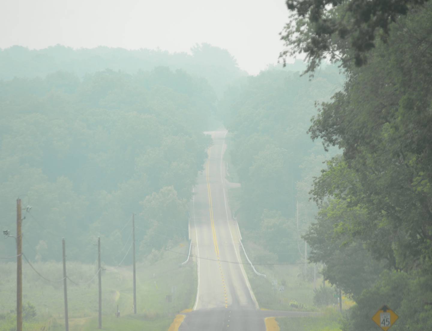 Smoke from wildfires in Canada has again drifted down to northern Illinois affecting air quality as seen by this photo of Lowell Park Road, north of Dixon, Tuesday morning.