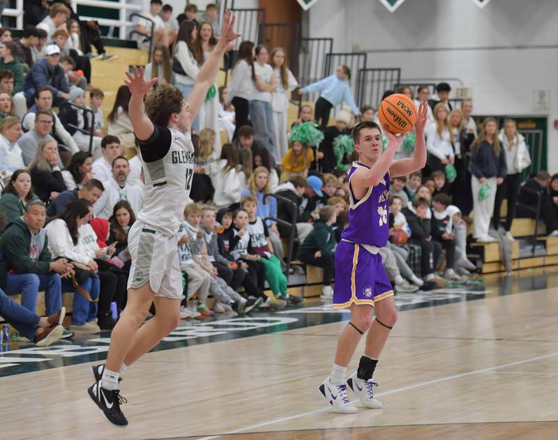 Downers Grove North’s Marius Razgaitis (right) shoots a three pointer as Glenbard West’s Jacob Harvanek defends during a game on January 23, 2026 at Glenbard West High School in Glen Ellyn.