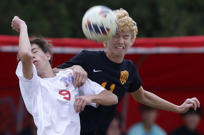Richmond-Burton's Jack Meyer heads the ball away fromMarian Central's Jan Bajda during the IHSA Class 1A Marian Central Regional Boys Soccer Final match on Tuesday, Oct. 22, 2024, at Marian Central High School in Woodstock.