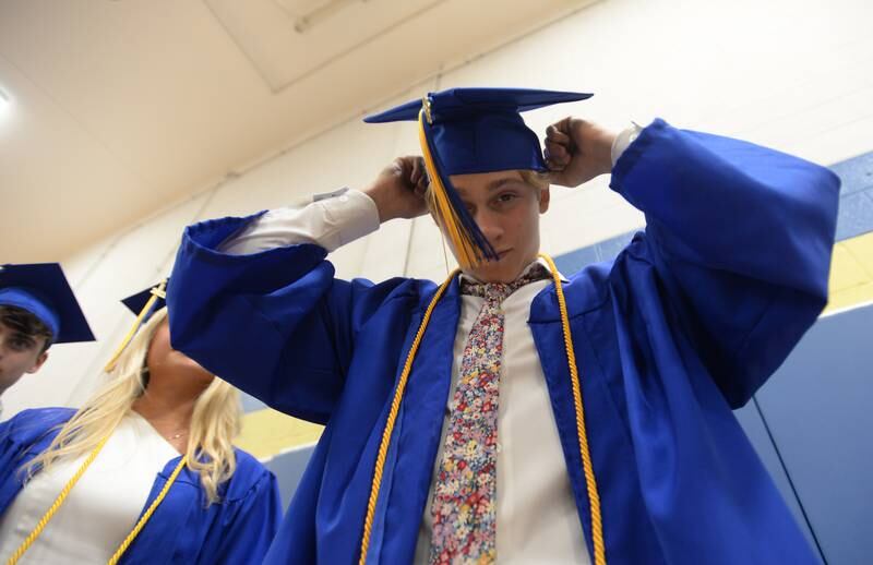 Lyons Township's Quinn Riordan of Western Springs puts his cap on as he prepares for graduation Wednesday May 25, 2022.