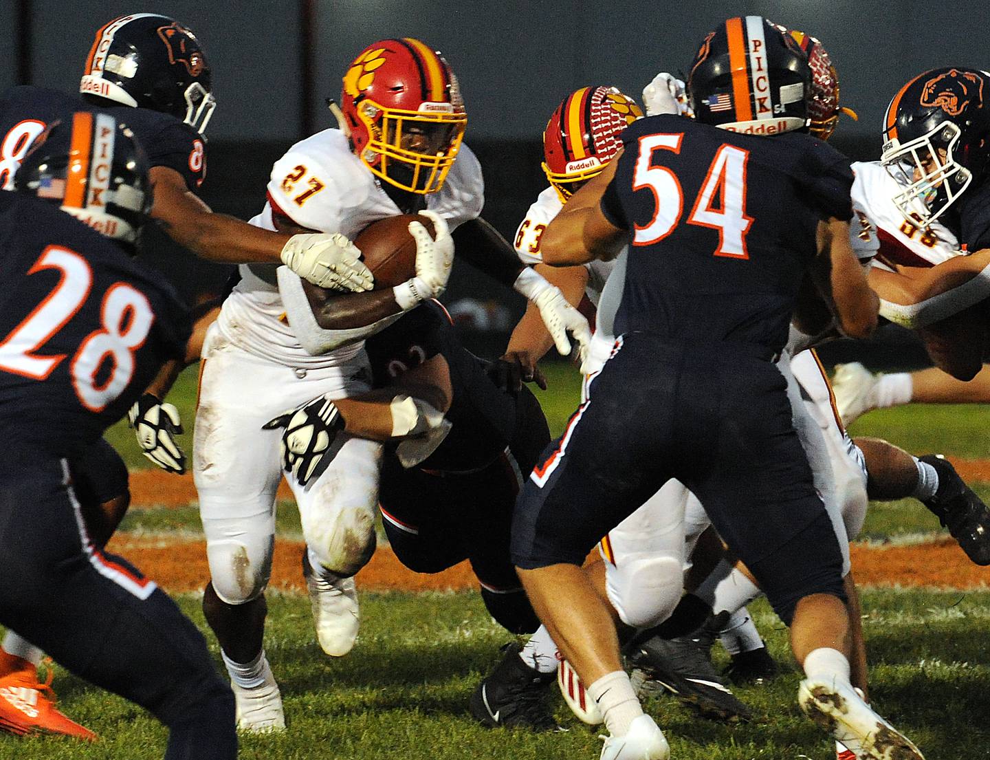 Batavia running back Jalen Buckley (27) plows through the Oswego line during a varsity football game at Oswego High School on Friday.