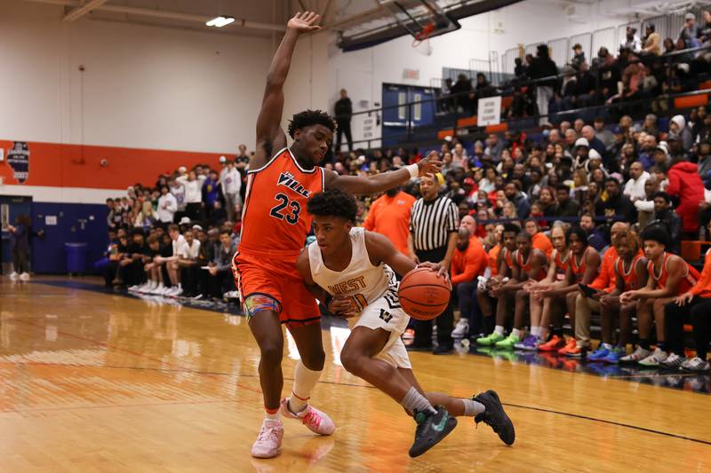 Joliet West’s Jeremy Fears drives to the basket against Romeoville’s Denonte Cunningham on Tuesday January 31st, 2023.