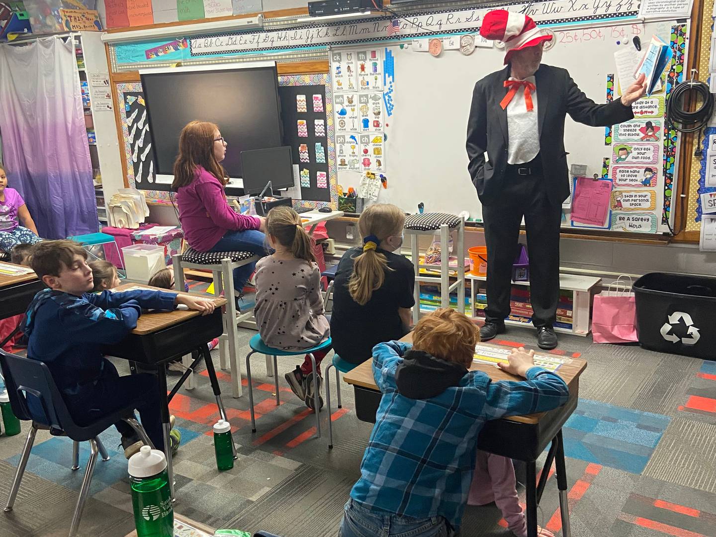 Bob Sondgeroth, Rock Falls Rotarian, reads Dr. Seuss stories to second grade students at East Coloma-Nelson School as a part of the Rock Falls Rotary volunteer reading program on Wednesday, March 2, birthday of Dr. Seuss.  Students were from the two second grade classes of Katie Merrell and Rebecca Repass.