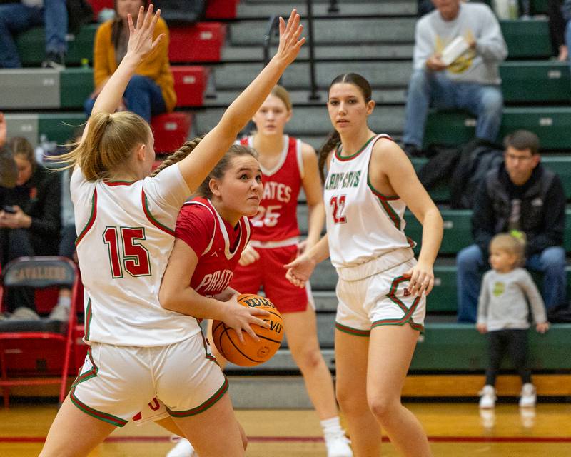Hailey Thrush (21) of Ottawa maneuvers ball around Margaret Boudreau (15) of LaSalle-Peru as she looks to lay ball up on Wednesday, December 17, 2025 at Sellet Gymnasium in LaSalle.