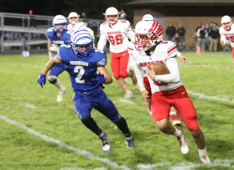 Oregon's Jakobi Donegan runs the ball down the field as Princeton's Lane Goskusky chases after him during the Class 3A playoff game on Friday, Nov. 1, 2024 at Princeton High School.