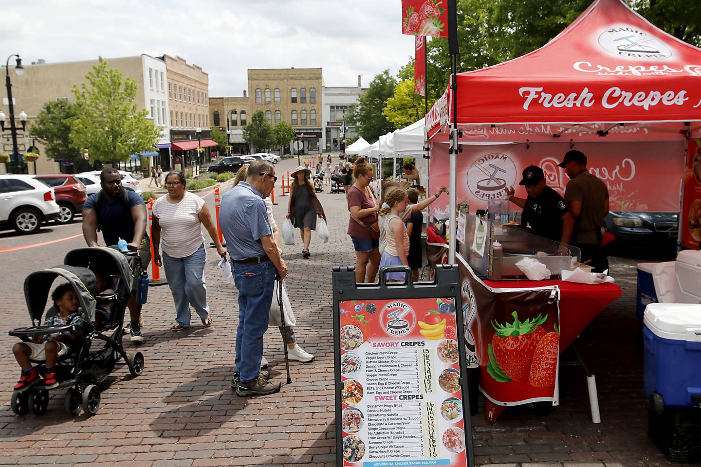 People shop at the Tuesday Woodstock Farmer's Market on June 24, 2025, around the Historic Woodstock Square.