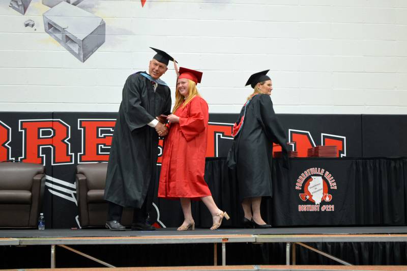 Forreston High School senior Lacie Williams accepts her diploma from Forrestville Valley School District Board of Education member Chip Braker during the Class of 2023's commencement on May 14, 2023. To the right is district Superintendent Sheri Smith. Williams is going into the workforce as a carpenter.