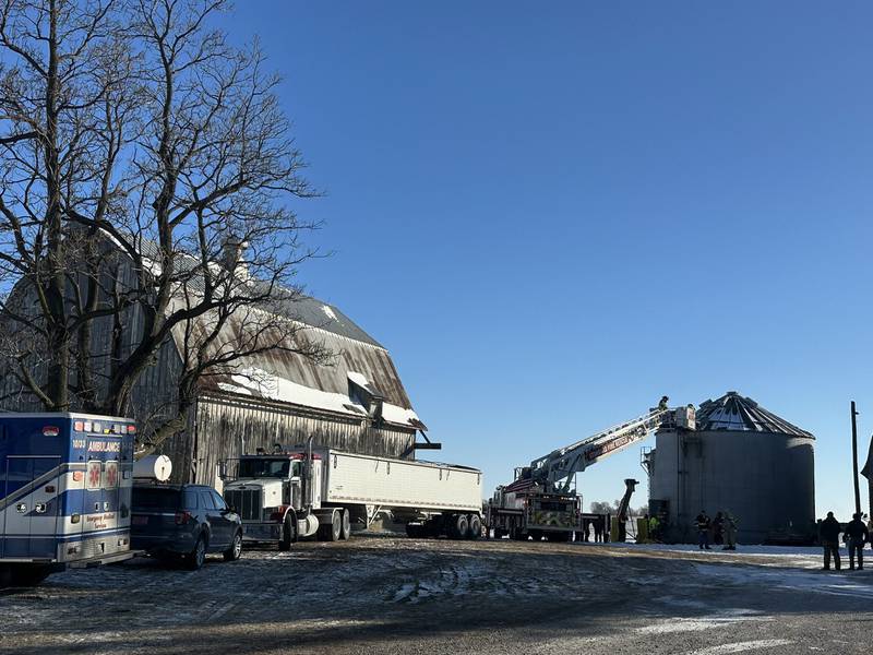 Emergency personnel use a ladder to access a grain bin during a rescue operation on a farm in the 13000 block of County Road 950 North just south of Granville on Monday, Jan. 26, 2026. Two people fell into the bin, prompting a response from OSF HealthCare lifeflight helicopters and local emergency crews.