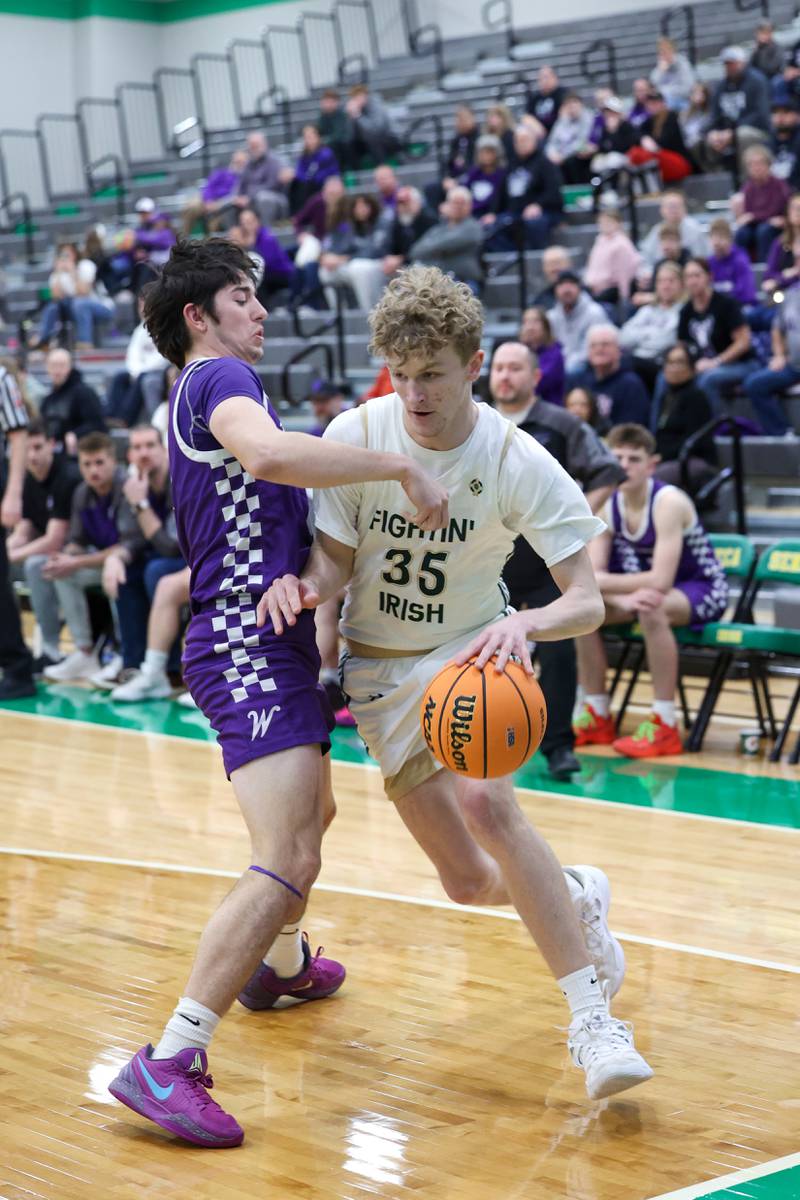 Bishop McNamara's Richard Darr drives against Wilmington's Ryan Kettman during Bishop McNamara's 61-24 victory over Wilmington in the IHSA Class 2A Seneca Sectional semifinal on Tuesday, March 3, 2026.