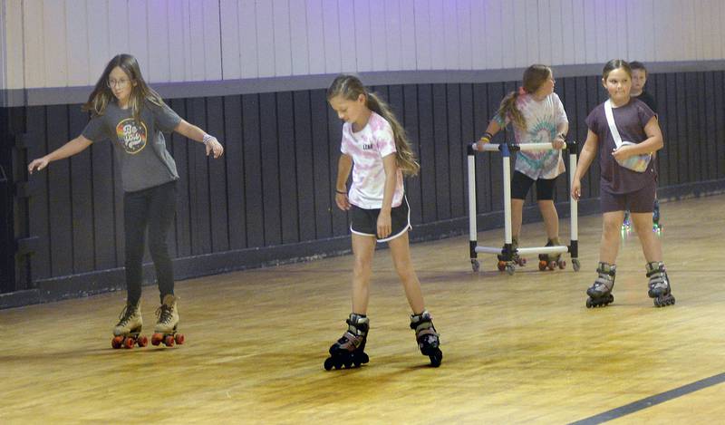 Several roller skaters make their way around the rink Wednesday, June 28, 2023, at the Paramount in Ottawa during the All Parks Skating Party.