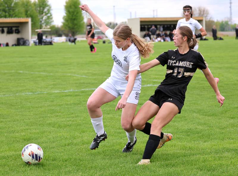 Kaneland's Bella Gruber (left) and Sycamore's Addison Rodriguez go after the ball during their game Wednesday, April 29, 2026, at Sycamore High School.
