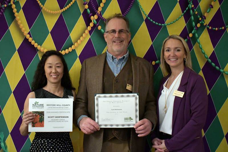 Scott Mortenson (middle) was honored as the Will County Forest Preserve District 2025 Volunteer of the Year on April 1, 2026.