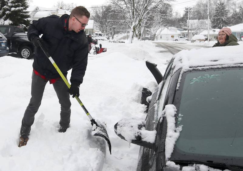 Dylan Cranden, from DeKalb, digs his car out Friday, Jan. 12, 2024, after early morning snow covered his vehicle. Several inches of snow blanketed DeKalb County Friday on top of the 6 inches that fell on the area earlier this week.