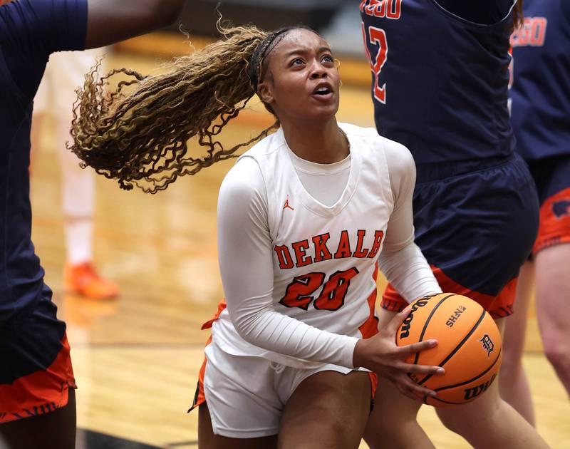 DeKalb's Zora Watts goes to the basket between two Oswego defenders during their game Monday, Jan. 5, 2026, at DeKalb High School.
