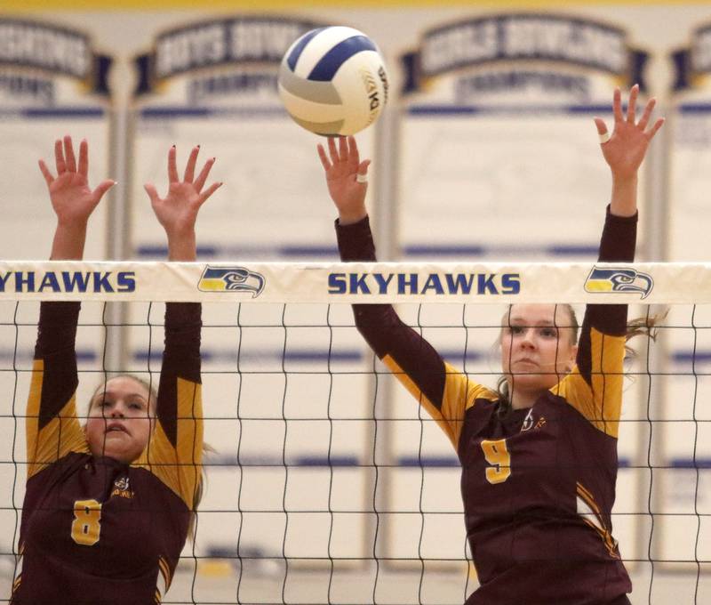 Richmond-Burton’s Adelynn Woods, left, and Reagan Wisniewski block in varsity girls volleyball at Johnsburg High School in Johnsburg on Thursday, August 25, 2025.