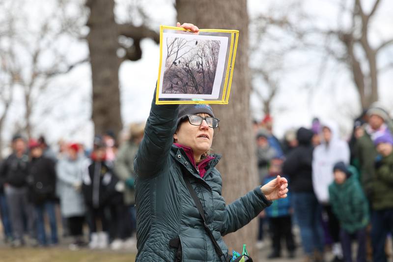 Interpretive Naturalist Angela Rafac holds up a recent photo taken of 18 eagles in one tree seen at the Four Rivers Environmental Education Center for a hiking tour at the annual Eagle Watch program in Channahon. Illinois has the 2nd largest eagle population in the winter.