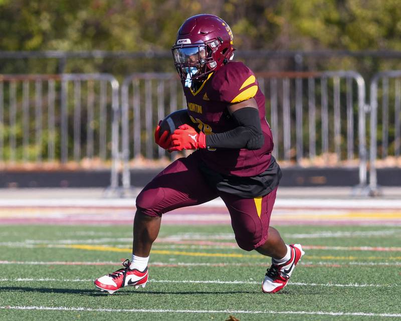 Montini Catholic's Isaac Alexander (28) runs the ball for some yards before being brought down by Coal City's Brody Widlowski (3) during the 4A quarterfinals game on Saturday Nov. 15, 2025, held at Montini Catholic High School.