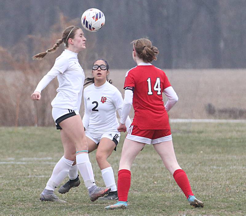 L-P's Danica Scoma puts a header on the ball as teammate Vicky Tejada watches while Streator's Bridgit McGurk defends on Friday, March 24, 2023 in Streator.