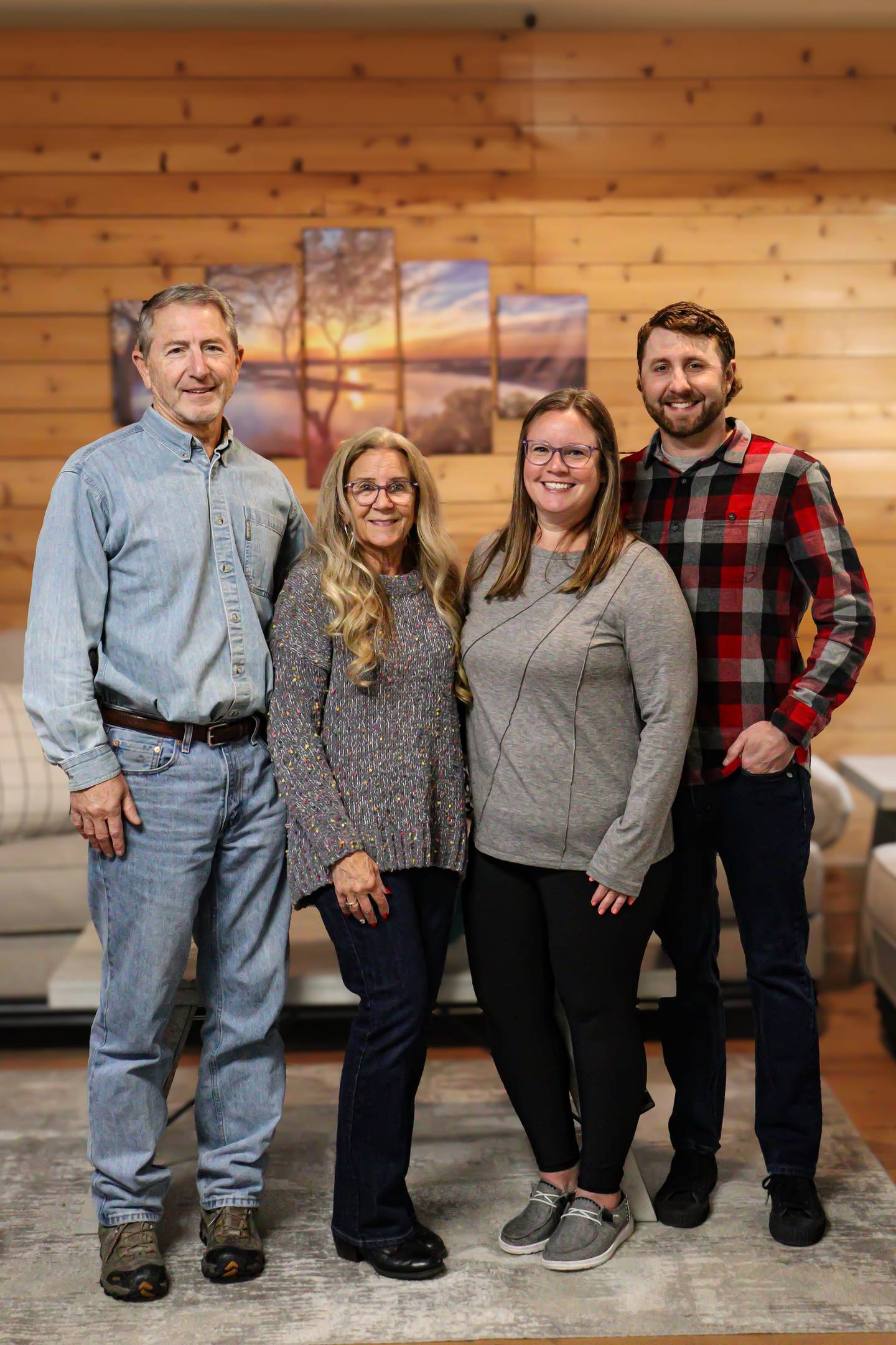 Steve and Tina Nelson, left, stand with their son and daughter-in-law Ryan, right and Annie Nelson inside the family's longtime business, Nelsons Home Furnishings and Outlet Center in Wilmington. After more than 42 years, Steve will pass the business on to Annie later this month.