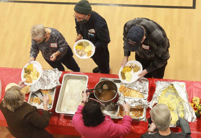 Guests enjoy being served a Thanksgiving meal during the 2nd Annual Fox Lake Community Thanksgiving Dinner at Lakefront Park in Fox Lake. Tanya and Tim Hill, of Fox Lake, Kim Lunstrom, of Grayslake and many other volunteers and community leaders helped to prepare and serve the dinner.