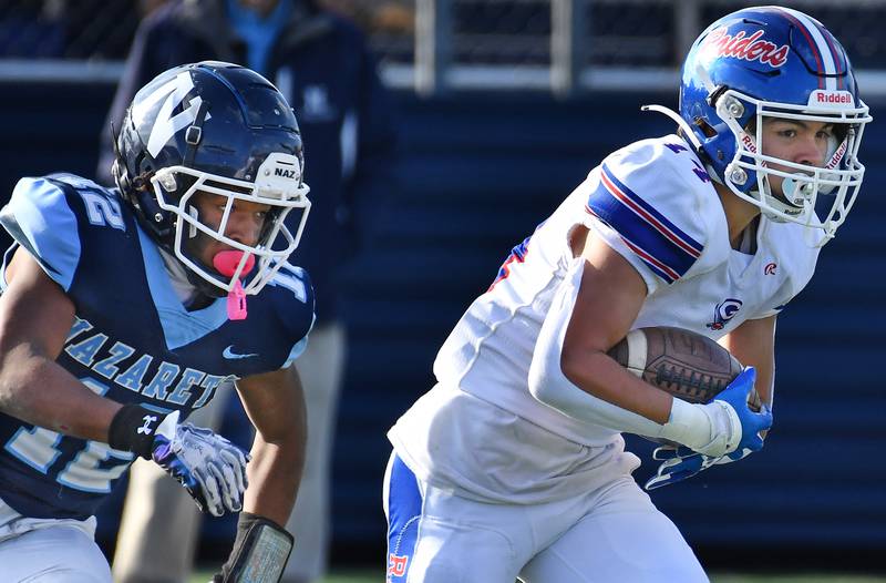 Glenbard South's Shaun Aderholt (right) runs from Nazareth's Edward McClain Jr during a Class 5A second round game on Nov. 4, 2023 at Nazareth Academy in LaGrange Park.