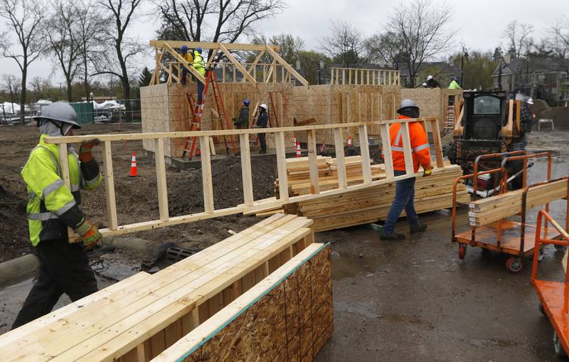 Volunteers construct tiny shops Monday, May 1, 2023, at the new McHenry Riverwalk Shoppes at Miller Point Park in McHenry. McHenry High School students joined volunteers from Habitat for Humanity of McHenry County, McHenry Parks and Recreation Department staff, and contractors to build the shops at the site.