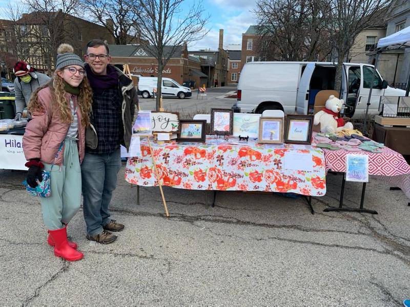 Evelyn Gibbons, 13, of Geneva, and her father, Adam Gibbons, at her first art show at the Open Air Holiday Market in Winnetka. She sold 37 prints and donated 20% of her sales to the Nature Conservancy and The Conservation Foundation of Naperville.