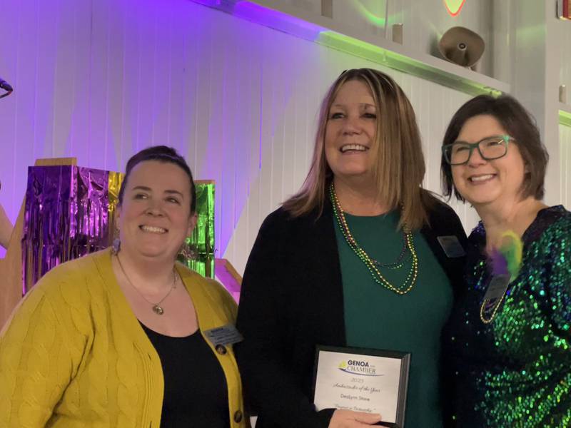 Carissa Brendle and Krissy Johnson stand next to Dealynn Stone, middle, who was given the Genoa Area Chamber of Commerce's Ambassador of the Year award on Feb. 11, 2026.