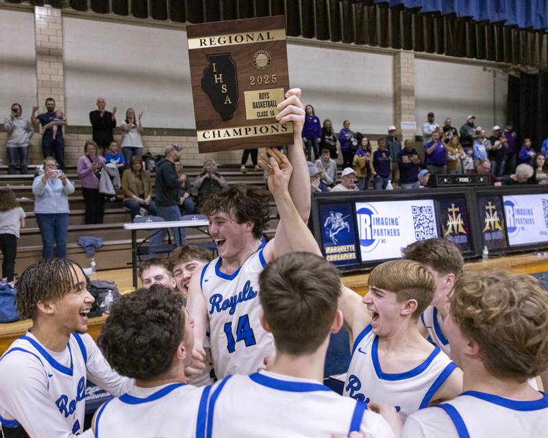 Players from Hinckley-Big Rock celebrate after receiving their championship plaque after the Class 1A Regional Championship game on February 28, 2025 at Bader Gym.
