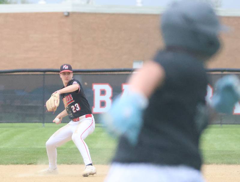 Henry-Senachwine's Landon Harbinson throws out Woodland's Blaine Bates at first basse on Tuesday, May 12, 2026 at Woodland High School.