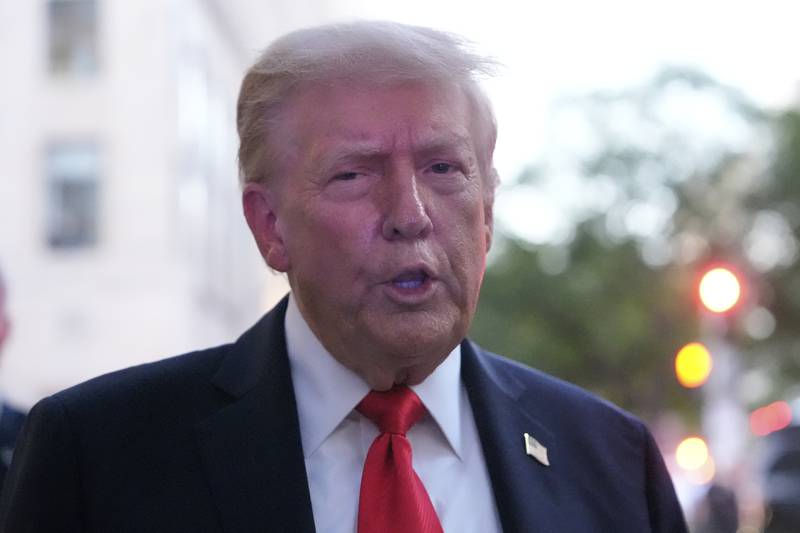 President Donald Trump speaks to reporters before he enters a restaurant near the White House, Tuesday, Sept. 9, 2025, in Washington, to have dinner. (AP Photo/Alex Brandon)