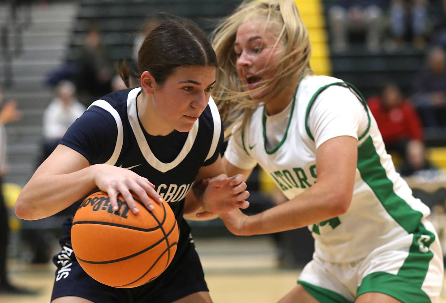 Cary-Grove's Kennedy Manning is fouled by Crystal Lake South's Gracey LePage during a Fox Valley Conference girls basketball game on Friday, Jan. 23, 2026, at Crystal Lake South High School.