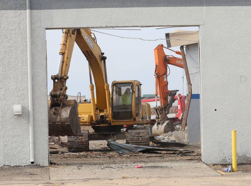 An excavator demolishes a portion of the Bill Walsh Coronet Dodge Chrysler Jeep RAM dealership on Tuesday, Feb. 17, 2026 in Peru.